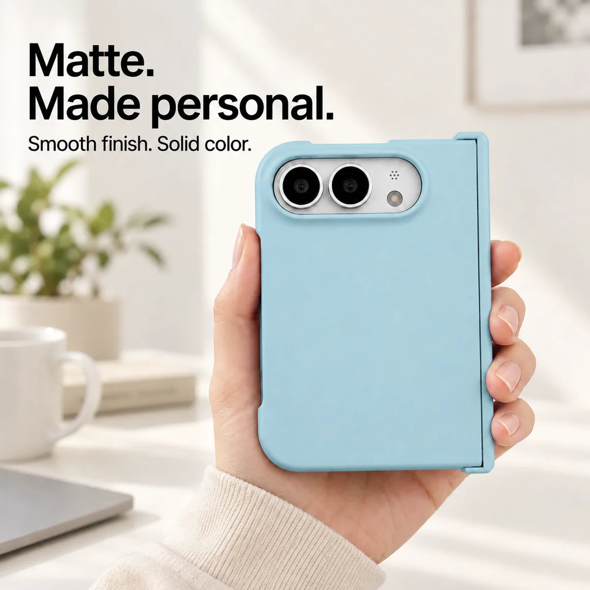 Sky Blue matte iPhone Ultra case held in one hand, with a smooth solid-color rear shell and silver camera area. #color_Glacier Blue