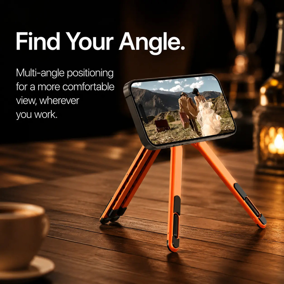 Cosmic Orange magnetic tripod stand holding a Burgundy iPhone displaying the original movie scene. #color_Cosmic Orange