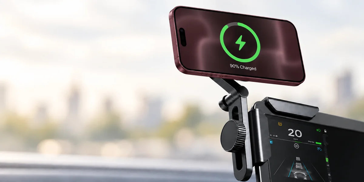Orange phone charging in landscape on a compact black mount clipped to a car display corner.
