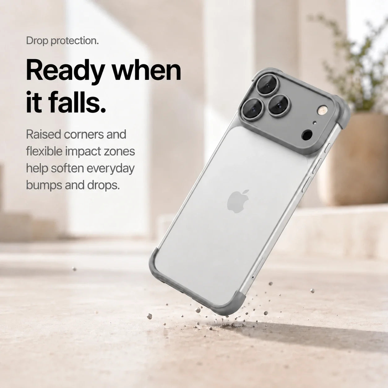 Gray phone bumper shown landing on a protected corner above a stone surface #color_Slate Gray